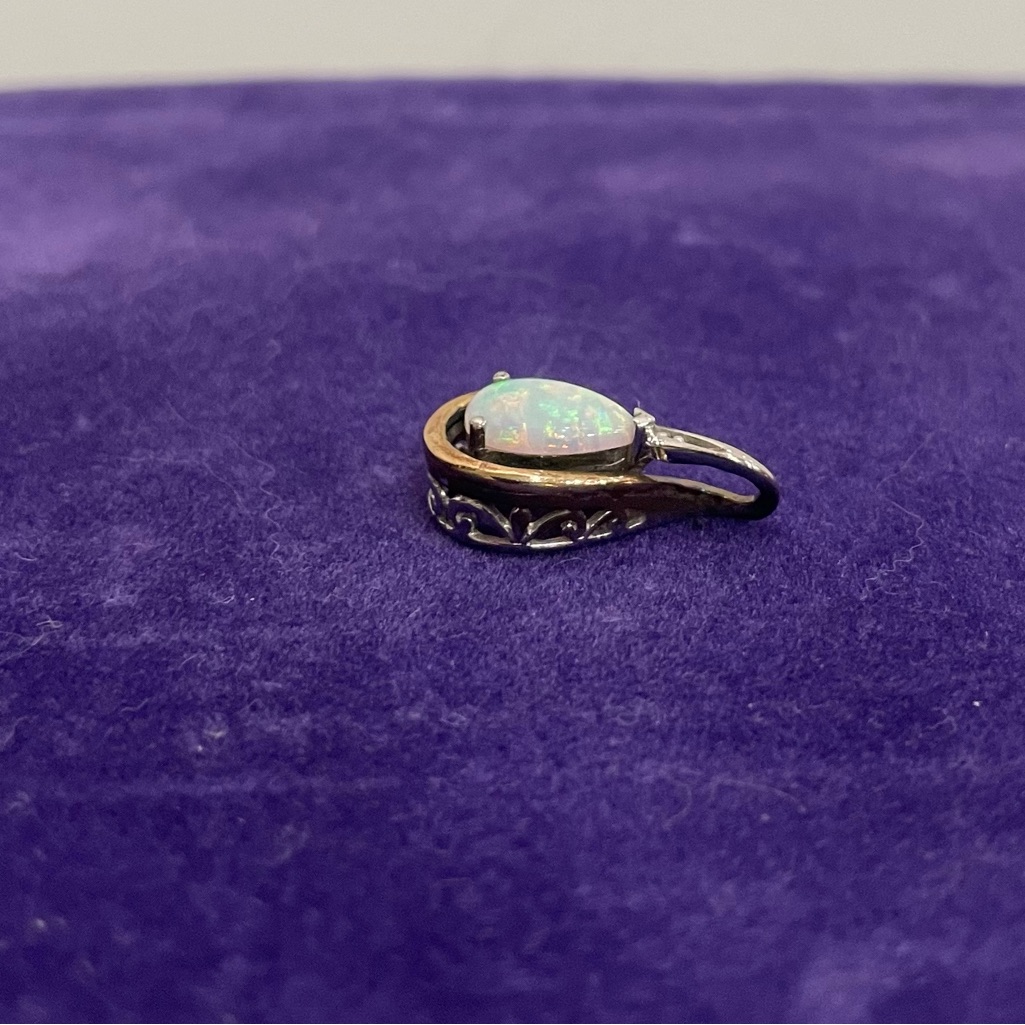 Sterling Silver And 10k Pear Shaped Simulated Opal Pendant.